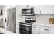 Modern kitchen with white cabinets, stainless steel appliances, and white countertops at 331 E Pierce St, Tempe, AZ 85288