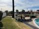 Kidney shaped pool with surrounding landscaping at 4461 E Flower St, Phoenix, AZ 85018