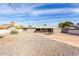 Sun-drenched backyard, featuring a covered patio and trampoline at 509 E Melrose Dr, Casa Grande, AZ 85122