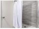 Shower stall with gray tile walls and a white shower curtain at 509 E Melrose Dr, Casa Grande, AZ 85122