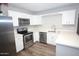 Modern kitchen with stainless steel appliances and white cabinets at 523 N Criss St, Chandler, AZ 85226