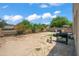 Large backyard with a spacious grass area and a built-in BBQ grill at 5677 S 239Th Dr, Buckeye, AZ 85326