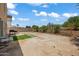 Landscaped backyard with artificial turf and a patio area at 5677 S 239Th Dr, Buckeye, AZ 85326