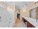 Bathroom with bathtub, double vanity, and access to the walk-in closet at 5677 S 239Th Dr, Buckeye, AZ 85326