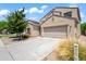 Two-story house with a large driveway and landscaping at 5677 S 239Th Dr, Buckeye, AZ 85326