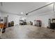Garage with car, workbench, and various storage items at 5677 S 239Th Dr, Buckeye, AZ 85326