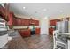 Modern kitchen featuring dark wood cabinets, stainless steel appliances, and an island at 5677 S 239Th Dr, Buckeye, AZ 85326