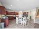 Kitchen features dark wood cabinets, stainless steel appliances, and a breakfast bar at 5677 S 239Th Dr, Buckeye, AZ 85326
