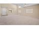 Large living room with high ceilings and neutral carpeting at 5677 S 239Th Dr, Buckeye, AZ 85326