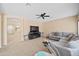 Spacious living room featuring a comfortable sectional sofa and a modern fireplace at 5677 S 239Th Dr, Buckeye, AZ 85326