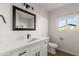 Clean bathroom with white vanity, and large mirror at 6801 S Palm Dr, Tempe, AZ 85283
