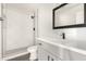 Modern bathroom with white vanity, marble shower, and black accents at 6801 S Palm Dr, Tempe, AZ 85283