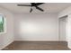 Bright bedroom with wood-look floors, ceiling fan, and closet at 6801 S Palm Dr, Tempe, AZ 85283