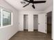 Well-lit bedroom with double closets and wood-look floors at 6801 S Palm Dr, Tempe, AZ 85283