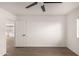 Bedroom with wood-look floors, ceiling fan and view of kitchen at 6801 S Palm Dr, Tempe, AZ 85283
