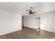 Bright bedroom with wood-look floors, ceiling fan, and spacious closet at 6801 S Palm Dr, Tempe, AZ 85283