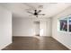 Spacious bedroom with wood-look floors, ceiling fan, and window at 6801 S Palm Dr, Tempe, AZ 85283