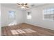 Spacious bedroom featuring wood-look floors and two windows at 700 W Northern Ave, Phoenix, AZ 85021