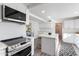 Bright kitchen featuring an island, stainless steel appliances, and white cabinetry at 700 W Northern Ave, Phoenix, AZ 85021