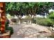 Landscaped backyard with flagstone patio and fire pit at 7032 W Aurora Dr, Glendale, AZ 85308