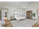 Bright main bedroom with a four poster bed, built in shelving, and hardwood floors at 7116 N 46Th Pl, Paradise Valley, AZ 85253