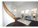 Living room with curved staircase and dark hardwood floors at 7146 W Globe Ave, Phoenix, AZ 85043