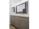 Vanity with gray cabinets, quartz countertop, and a large mirror at 7519 S 13Th Pl, Phoenix, AZ 85042