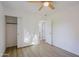 Bedroom with wood-look floors, ceiling fan and private bathroom access at 7519 S 13Th Pl, Phoenix, AZ 85042