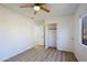 Bedroom with wood-look floors, ceiling fan, and private access to bathroom at 7519 S 13Th Pl, Phoenix, AZ 85042