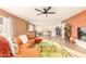 Retro-style living room with orange couch and wood floors at 8601 E Roanoke Ave, Scottsdale, AZ 85257