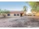 View of backyard with gravel, trees, and a tan house at 10422 E Edgewood Ave, Mesa, AZ 85208