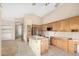 Spacious kitchen features wood cabinets, an island, and stainless steel appliances at 10422 E Edgewood Ave, Mesa, AZ 85208