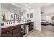 Spacious bathroom with double sinks, large mirrors, and a walk-in shower at 11311 E Upton Ave, Mesa, AZ 85212