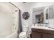 Bathroom with tub, toilet, and floating shelves at 11311 E Upton Ave, Mesa, AZ 85212
