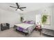 Bright bedroom with ceiling fan, large windows, and comfortable seating at 11311 E Upton Ave, Mesa, AZ 85212