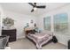 Spacious bedroom with a queen bed and large windows at 11311 E Upton Ave, Mesa, AZ 85212