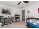 bedroom with a TV, shelving and twin bed at 11311 E Upton Ave, Mesa, AZ 85212