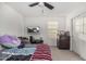 Bedroom with mounted TV, ceiling fan, and window blinds at 11311 E Upton Ave, Mesa, AZ 85212