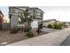 Two-story house with gray siding, white garage door, and landscaped front yard at 11311 E Upton Ave, Mesa, AZ 85212