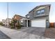 Two-story house with gray siding, white garage door, and landscaped front yard at 11311 E Upton Ave, Mesa, AZ 85212