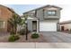 Two-story house with gray siding, white garage door, and landscaped front yard at 11311 E Upton Ave, Mesa, AZ 85212