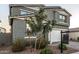 Two-story house with gray siding, white garage door, and landscaped front yard at 11311 E Upton Ave, Mesa, AZ 85212