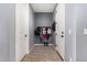 Small hallway with gray walls and wood-look floors, coat rack and dog bowl at 11311 E Upton Ave, Mesa, AZ 85212