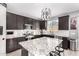 Modern kitchen with granite countertops, dark cabinetry, and stainless steel appliances at 11311 E Upton Ave, Mesa, AZ 85212
