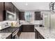 Modern kitchen with granite countertops and dark cabinetry at 11311 E Upton Ave, Mesa, AZ 85212