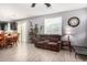 Bright living room with brown sofas and wood-look floors at 11311 E Upton Ave, Mesa, AZ 85212