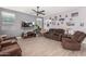 Relaxing living room with brown sofas, a large TV, and a cozy atmosphere at 11311 E Upton Ave, Mesa, AZ 85212