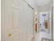 Light-filled hallway with tile flooring and built-in storage at 11500 E Cochise Dr # 1099, Scottsdale, AZ 85259