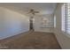 Bright bedroom with ceiling fan, built-in shelving, and window shutters at 1350 N 37Th Dr, Phoenix, AZ 85009