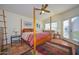 Bright bedroom with a four-poster bed and access to patio at 14423 W Morning Star Trl, Surprise, AZ 85374